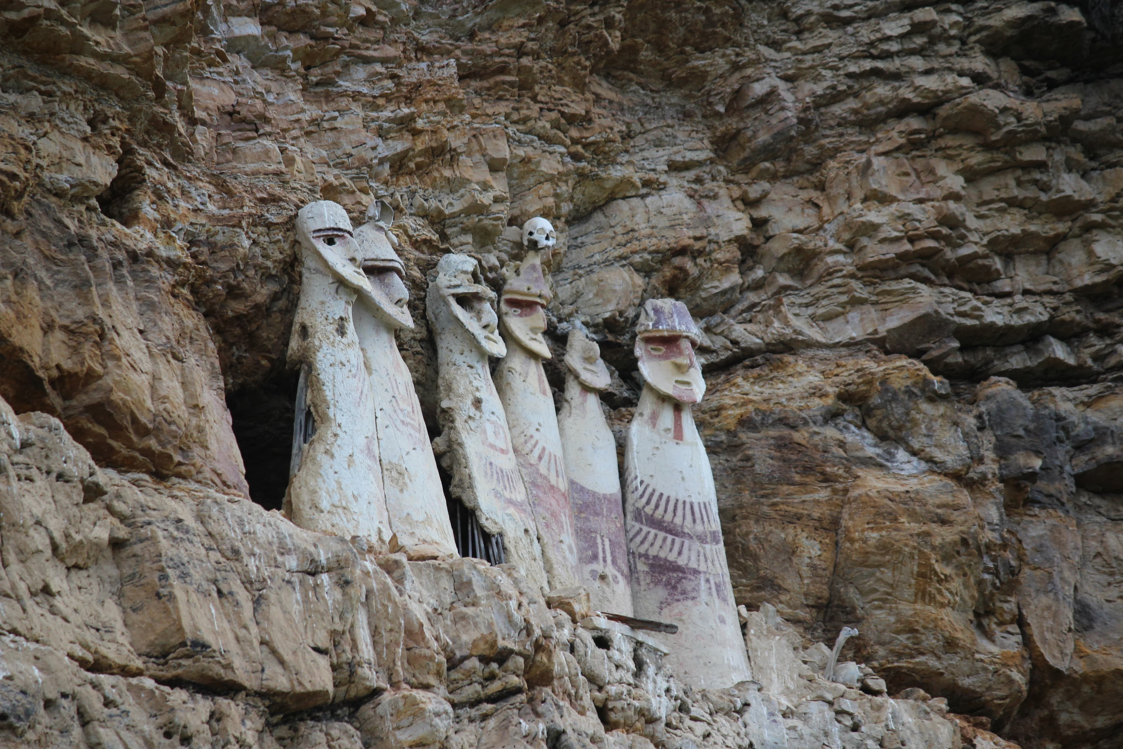 Chachapoya sarcophagi standing high in a rock face at Karajía